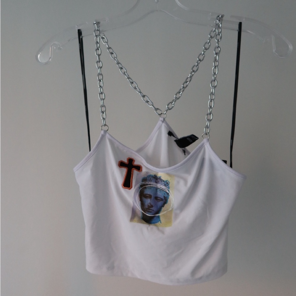 White crop top with silver chain straps and artsy print on front